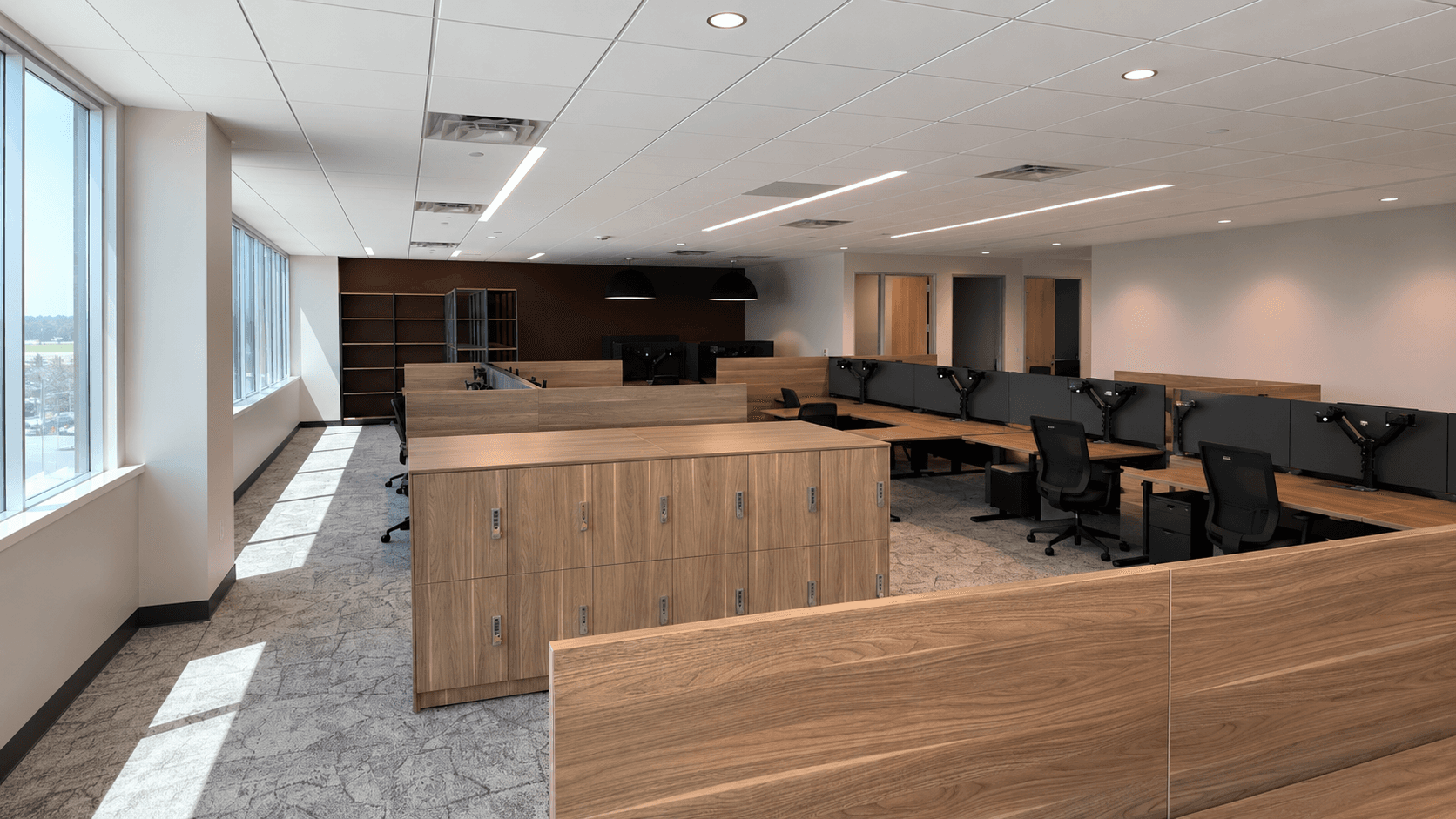 Five-member construction consulting team standing together in a commercial interior